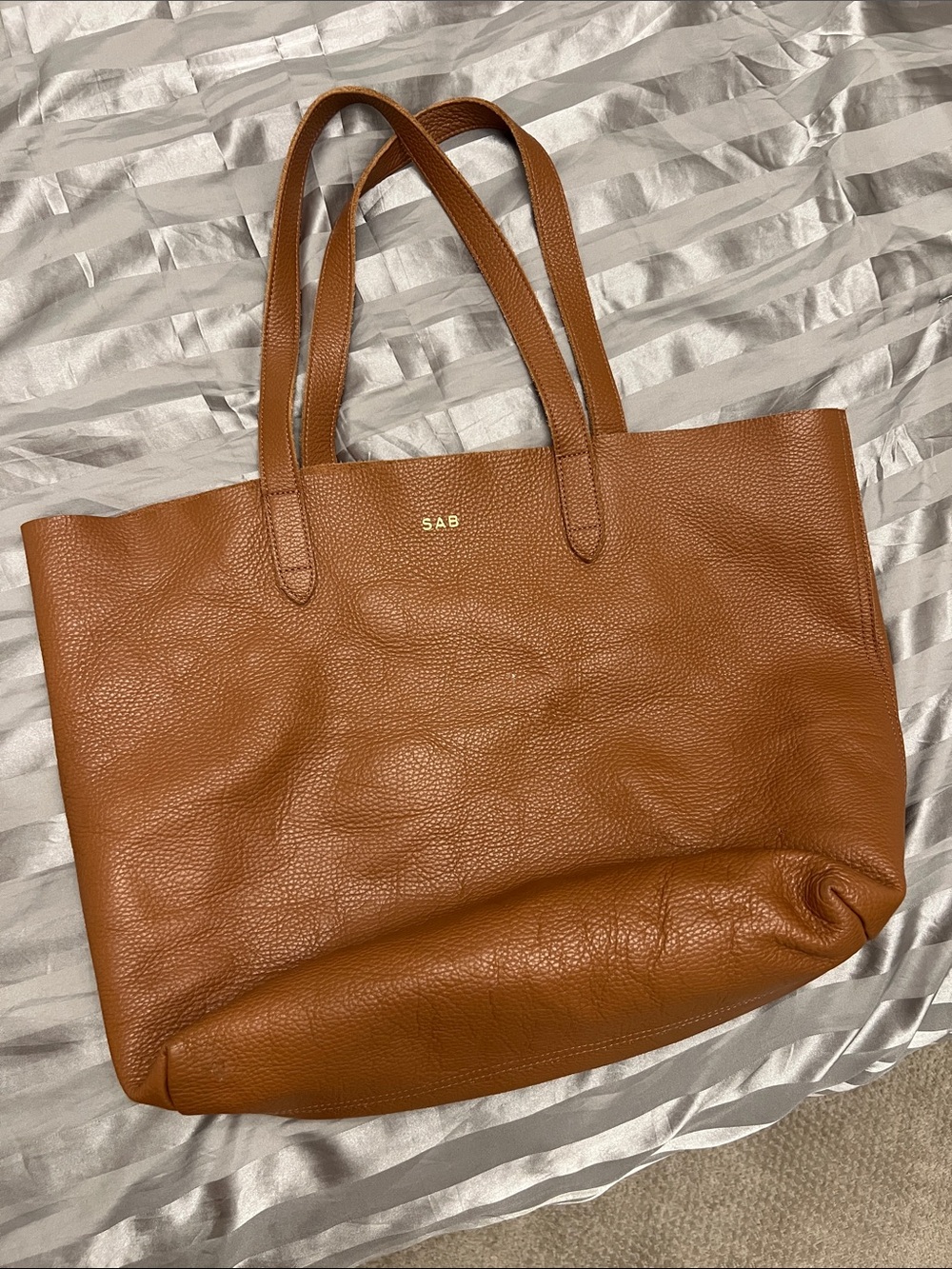 Cuyana tan leather tote with gold monogram